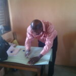 Image: trainer assisting a teacher in creating a resource