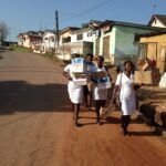 Student teachers carrying resource making materials to school
