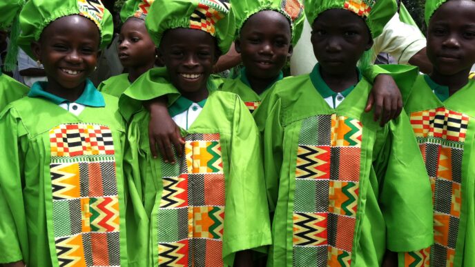 ghanaian child stood at chalkboar