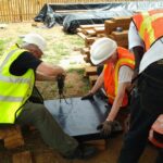 volunteers drilling plastic formwork