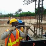 pouring concrete into plastic formwork