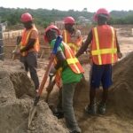 men diging sand