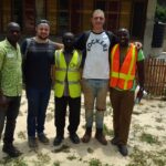 Ghana site team with two international volunteers